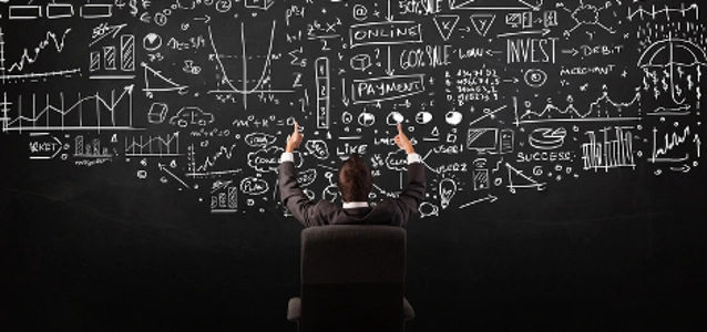 businessman-sitting-in-front-of-blackboard