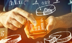 man-using-mobile-phone-with-drawings-of-charts